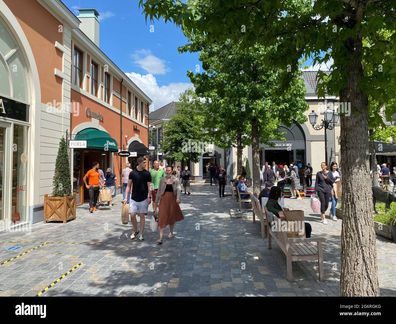 Roermond (designer outlet), Netherlands - July 1. 2021: View on exterior  shopping street with stores and people walking in summer Stock Photo - Alamy
