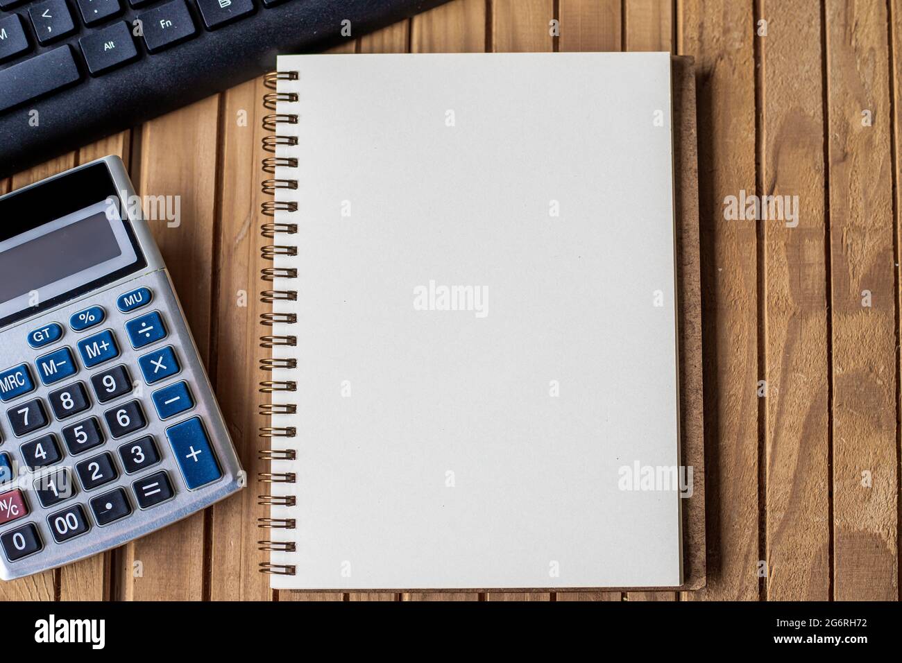 Blank Opened Spiral Notebook With A Calculator Keyboard Pen Placed Over  Table. Empty Lined Notepad And Pencil On Top Of A Desk With A Calculation  Stock Photo - Alamy