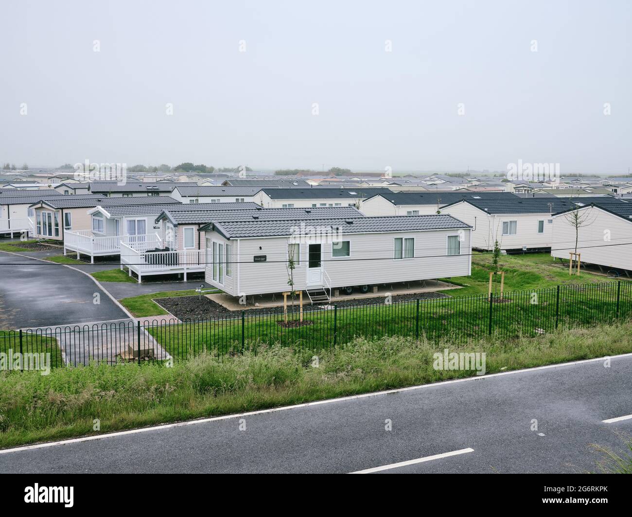 A large caravan park in the wet grey UK weather with grey sky - out of season Stock Photo