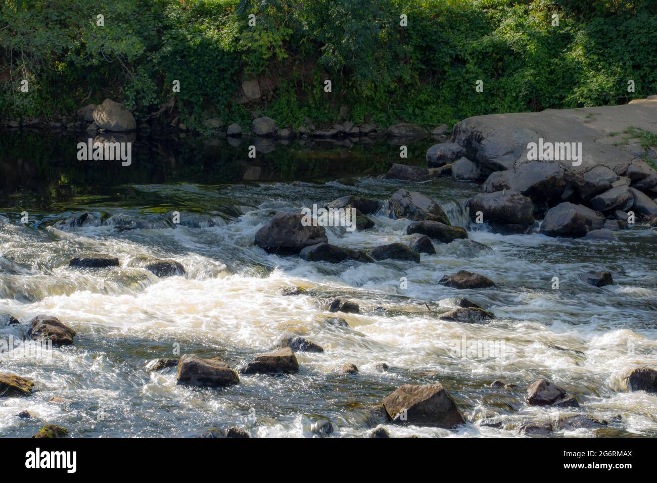 water flowing over rocks in a river in the French countryside Stock ...