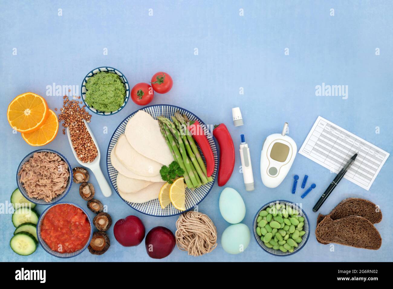 Low carb food for diabetics with all foods below 55 on the glycemic index with blood sugar monitoring & testing equipment & daily meal chart. Flat lay Stock Photo