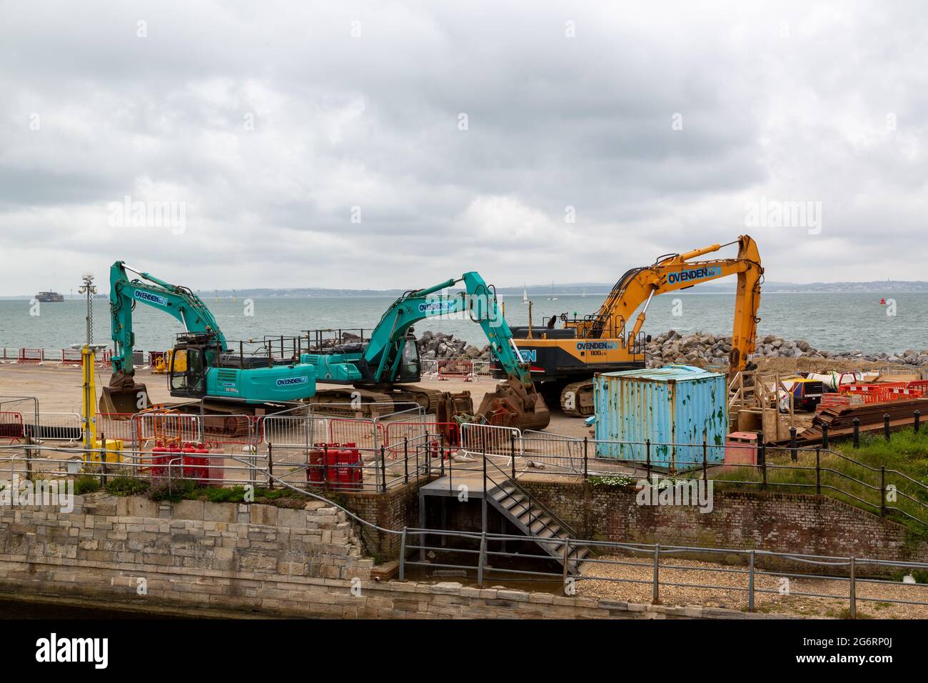 07-07-2021 Portsmouth, Hampshire, UK An excavator and a dumper working on coastal defences at Southsea with the sea in the background Stock Photo