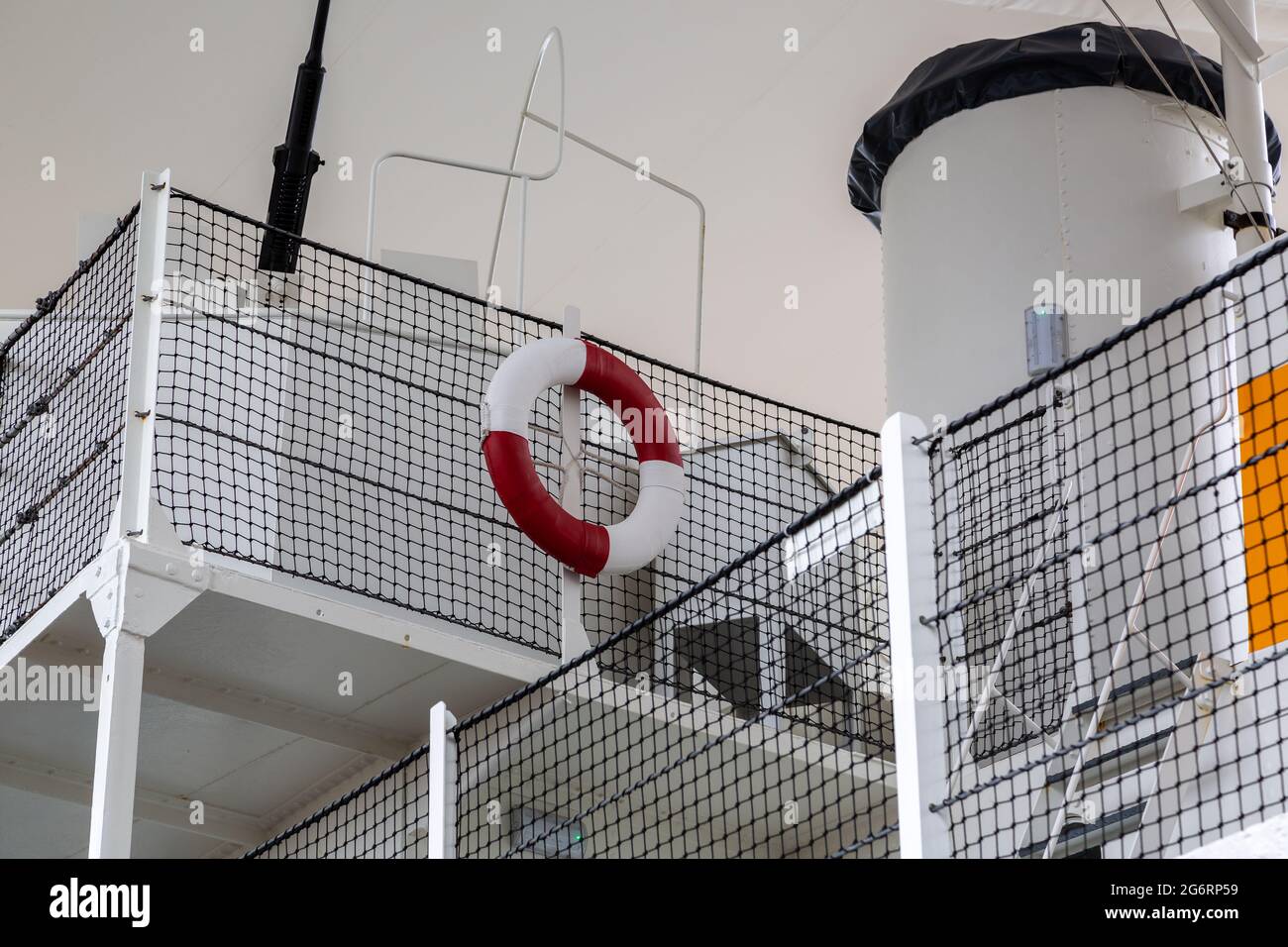A red and white life ring on the upper deck of an old ship Stock Photo
