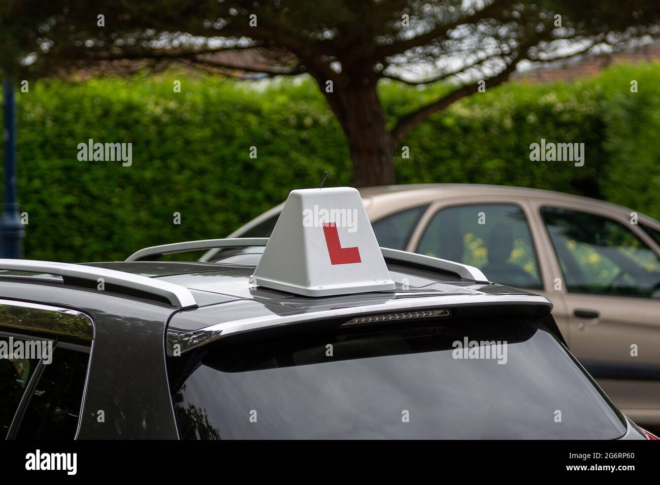 A learner driver sign on the roof of the car of a driving school Stock Photo