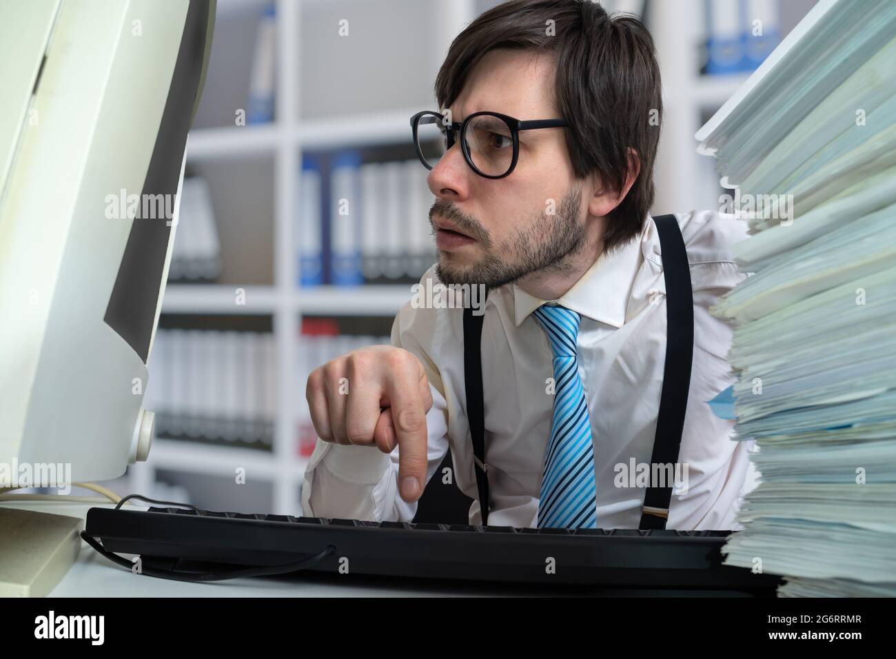 Young man is working with desktop computer in office. Stock Photo