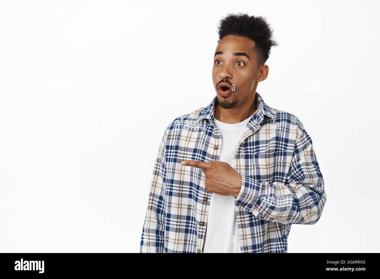 Wow look that way. Impressed african american man pointing left