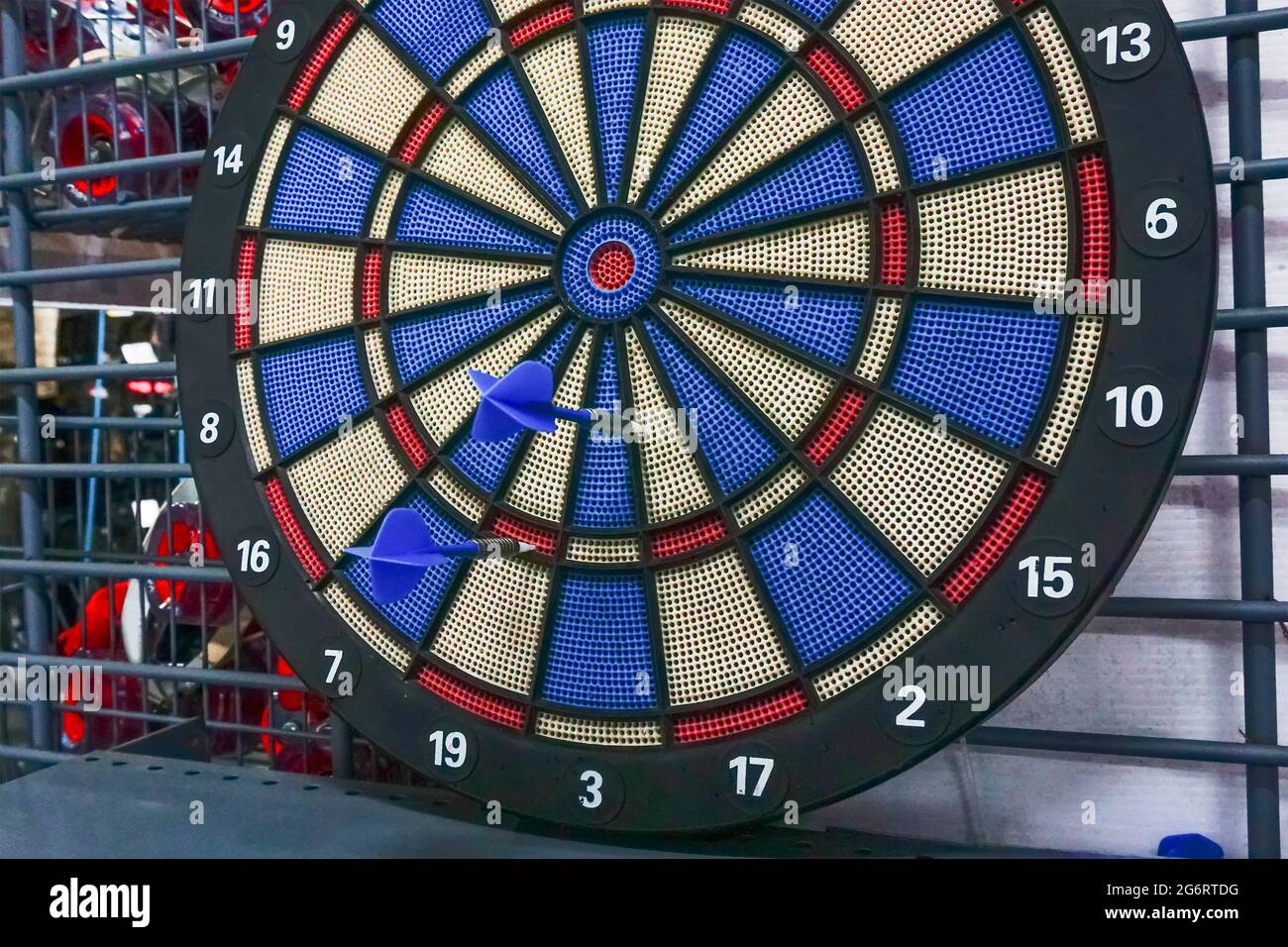 Darts is a sport in which small missiles/torpedoes/arrows/darts are thrown  at a circular dartboard fixed to a wall. Two darts failed to hit bulls-eye  Stock Photo - Alamy