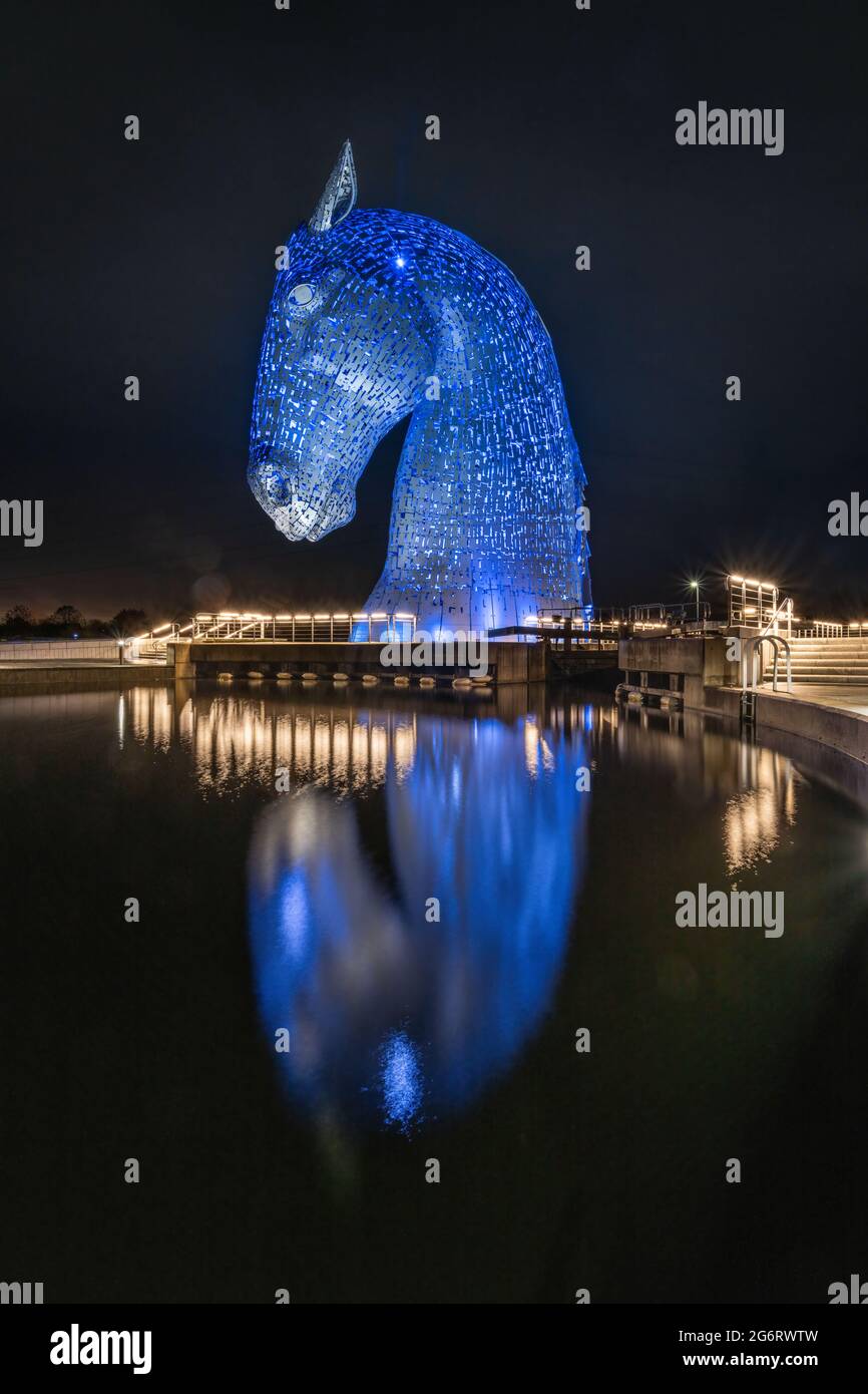 A dark, wet, raining autumnal evening photographing the lit up steel horse head sculptures created by Andy Scott. Stock Photo