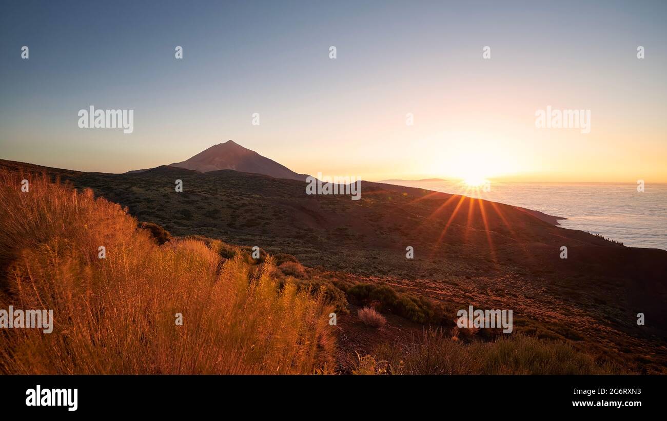Landscape with volcano Pico de Teide above clouds at beautiful sunset. Tenerife, Canary Islands, Spain. Stock Photo