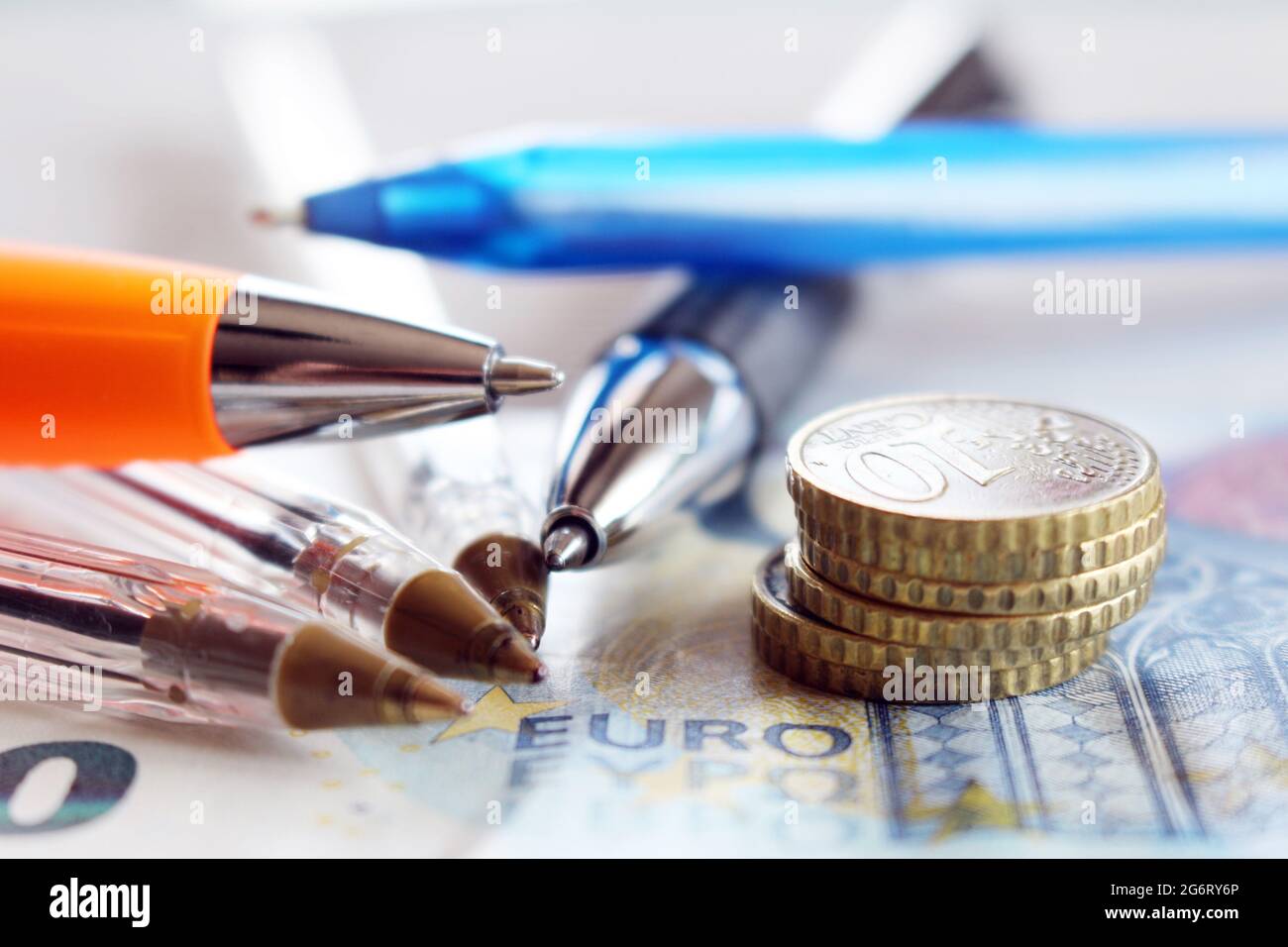 Assembly approves the financial statements. Above detail business view, pen, euro coins, on office desk, finance concept. Stock Photo