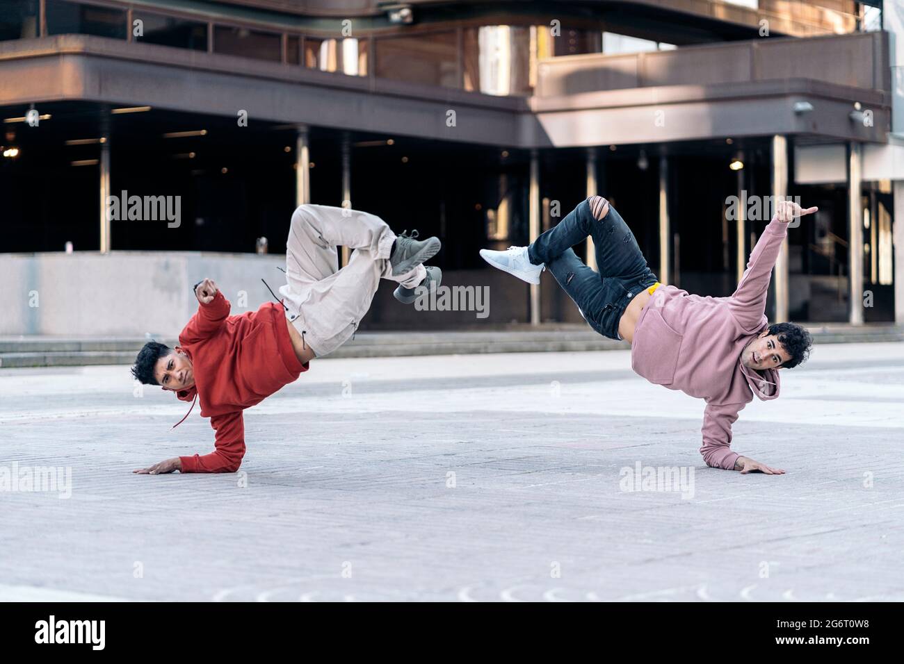 Amazing young men dancing break dance together in the city and having fun. Stock Photo