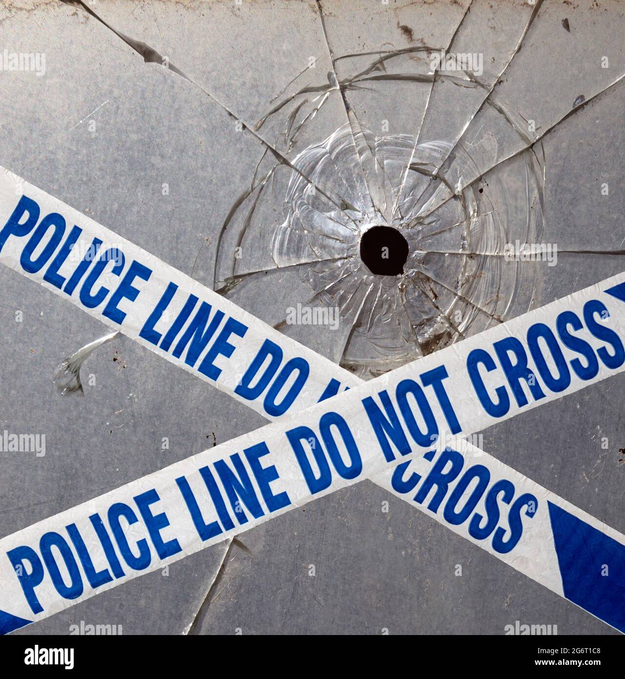 Bullet hole and Police tape. Stock Photo
