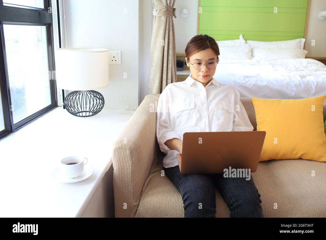 House wife working by laptop on sofa Stock Photo - Alamy