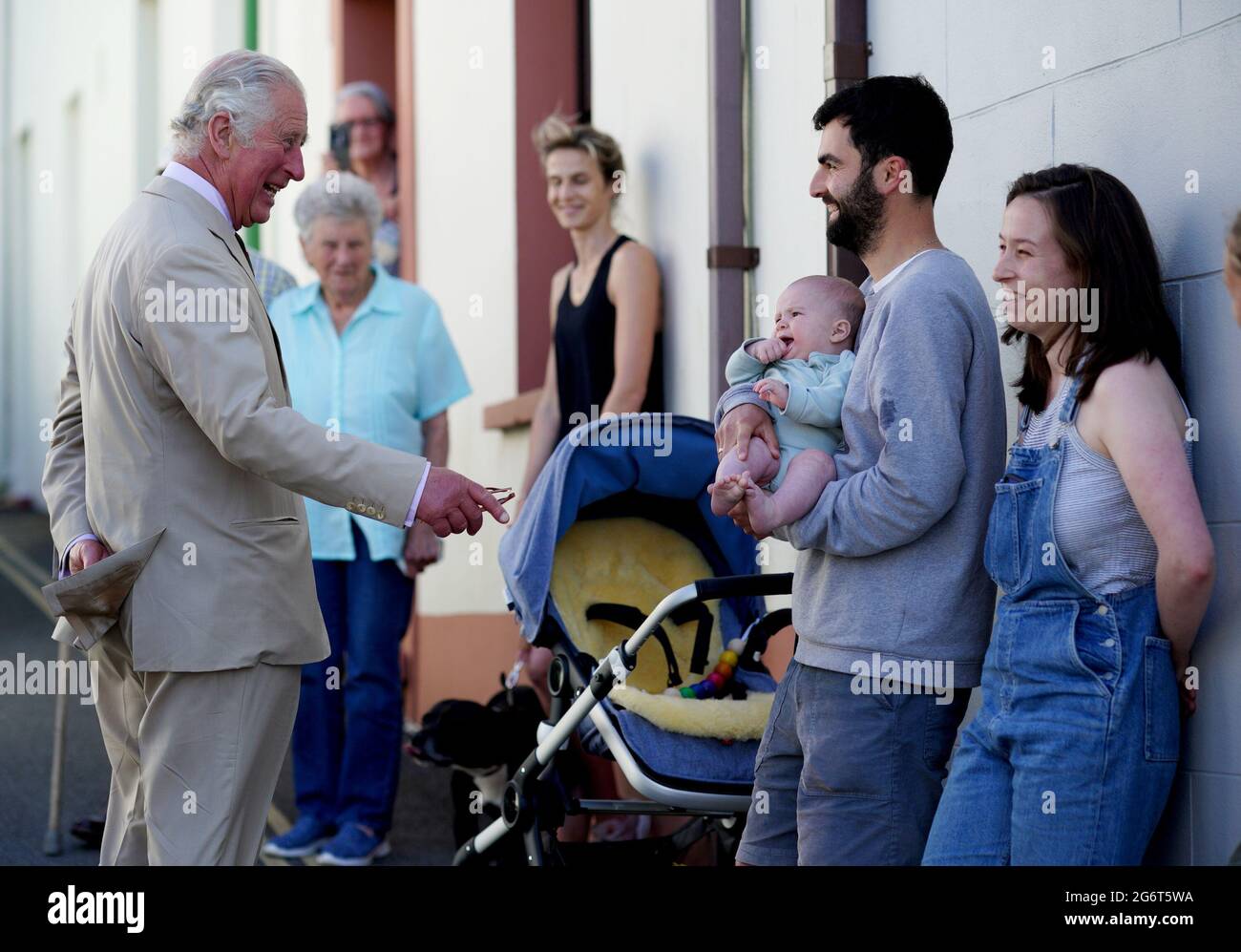 The Prince of Wales speaks to James Roden and Bethan Walker (right) about  their 4-month old baby, Idris Roden, as he walks around Haverfordwest,  Pembrokeshire, as part of a week long tour
