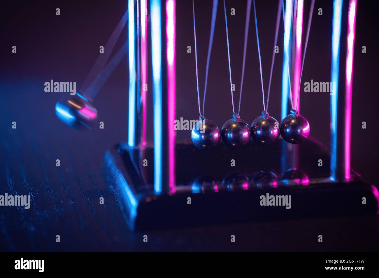 Newton cradle. Demonstrating gravity, action and reaction principle in