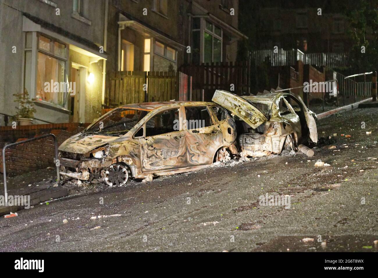 Pictured Two of the burned out cars outside the house of Adam Romain