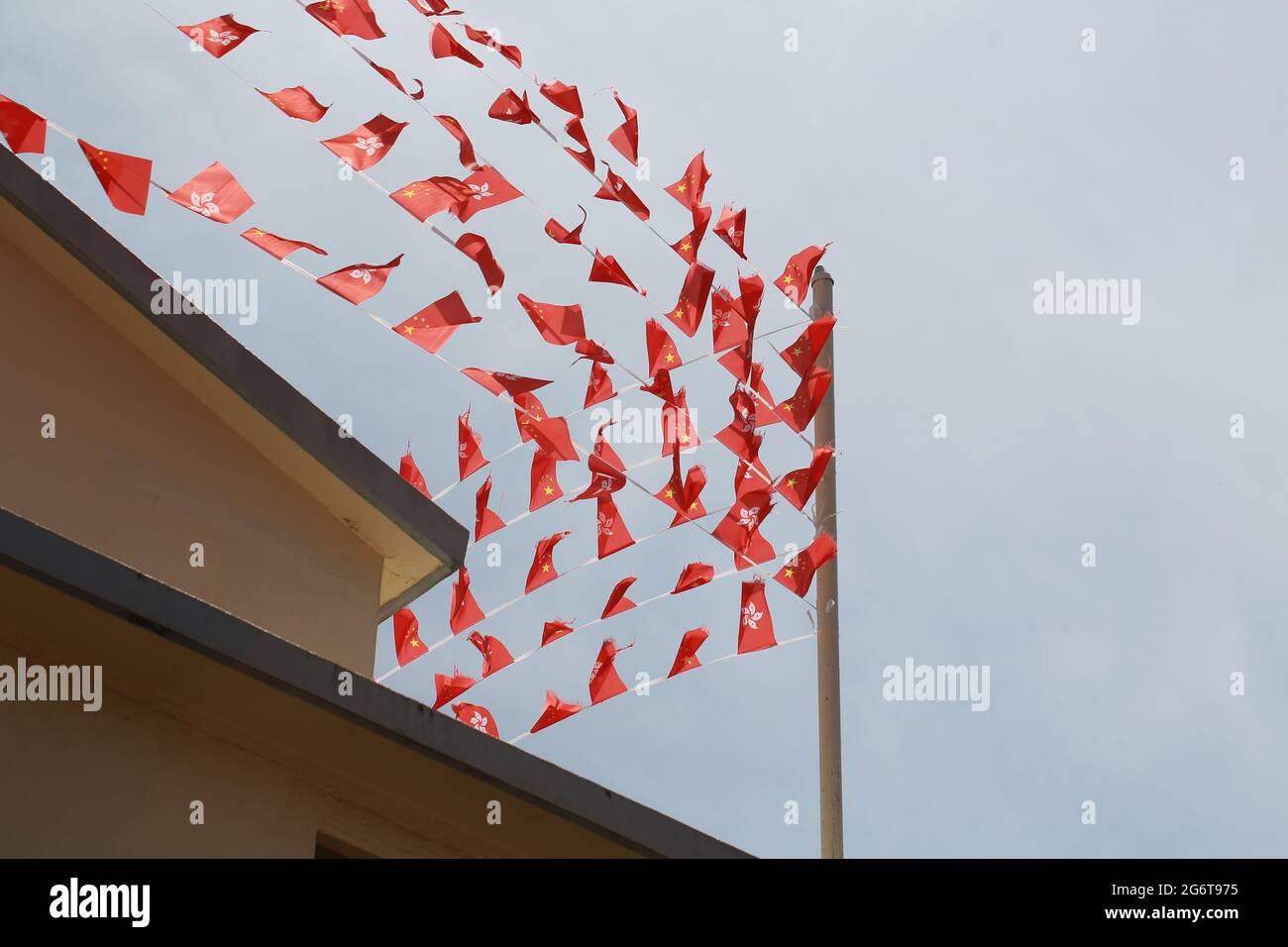 the hong kong flag and chinese flag against the sky in July one Stock Photo