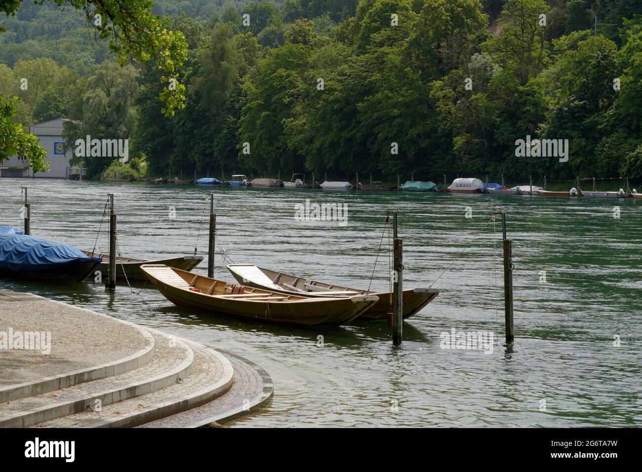 Wooden boats moored at promenade along Rhine river in Schaffhausen, Switzerland. They are called weidling boot in German language. Stock Photo