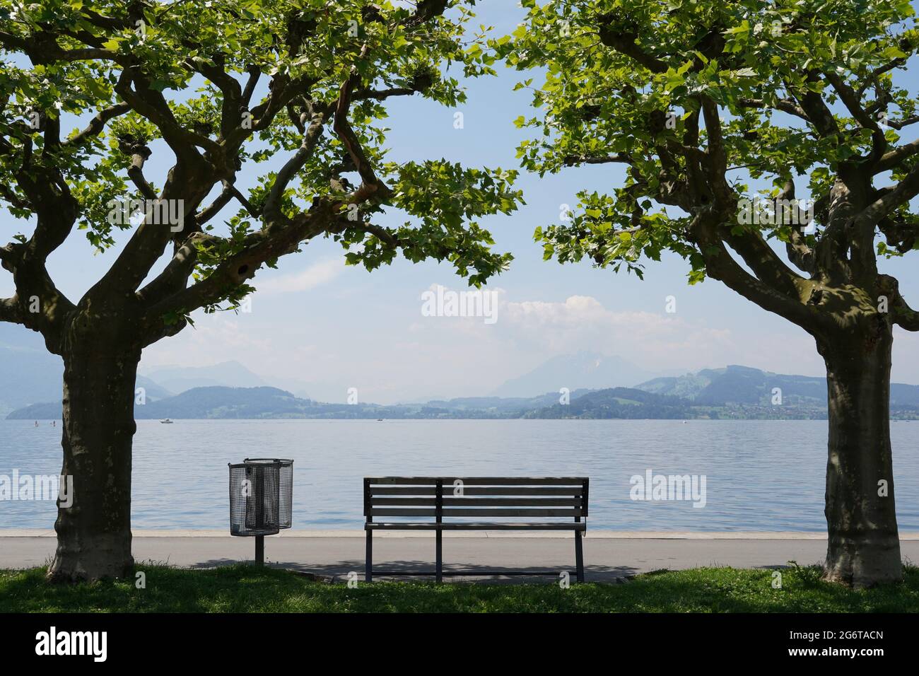 Empty bench at lake Zug in city Zug in Switzerland. The bench is placed