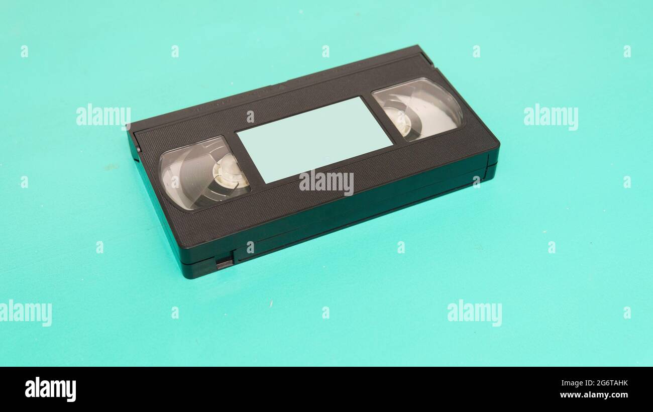 Close view of an old VHS tape with a blank label over a cyan surface Stock Photo Alamy