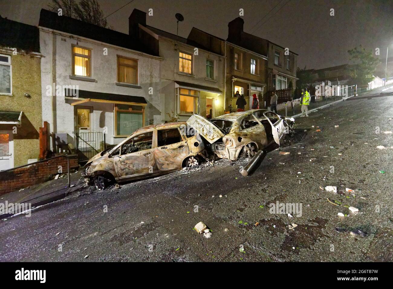 Pictured Two of the burned out cars outside the house of Adam Romain