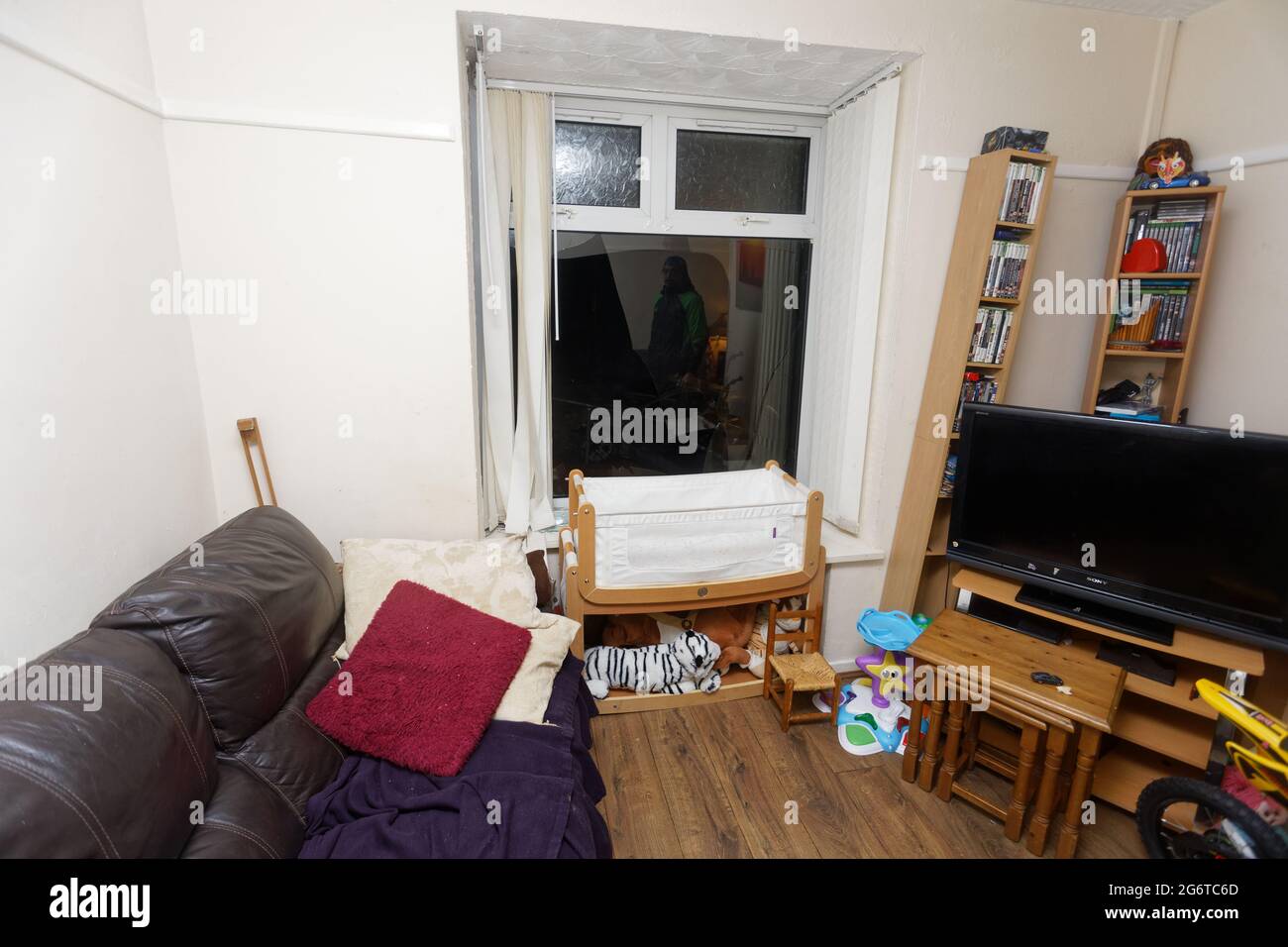 Pictured The smashed window in the front room at the house of Adam