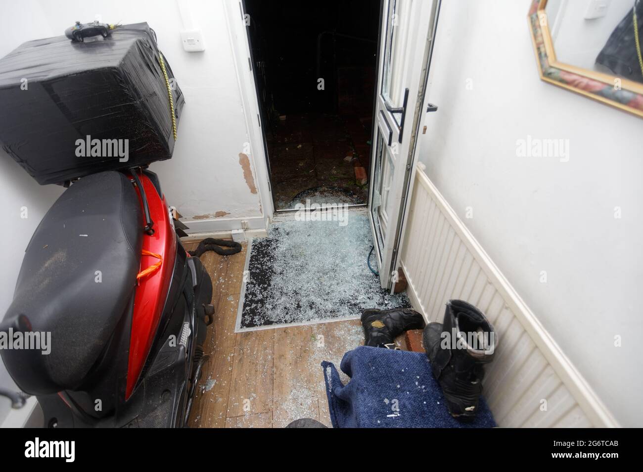 Pictured The smashed front door at the house of Adam Romain in Waun