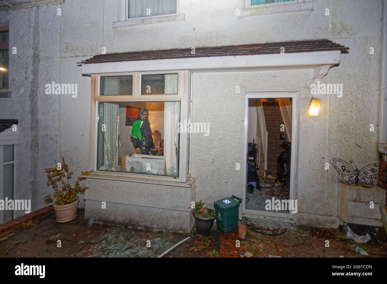 Pictured: The smashed window and front door at the house of Adam Romain in Waun-Wen Road in the Mayhill area of Swansea, Wales, UK. Thursday 20 May 20 Stock Photo