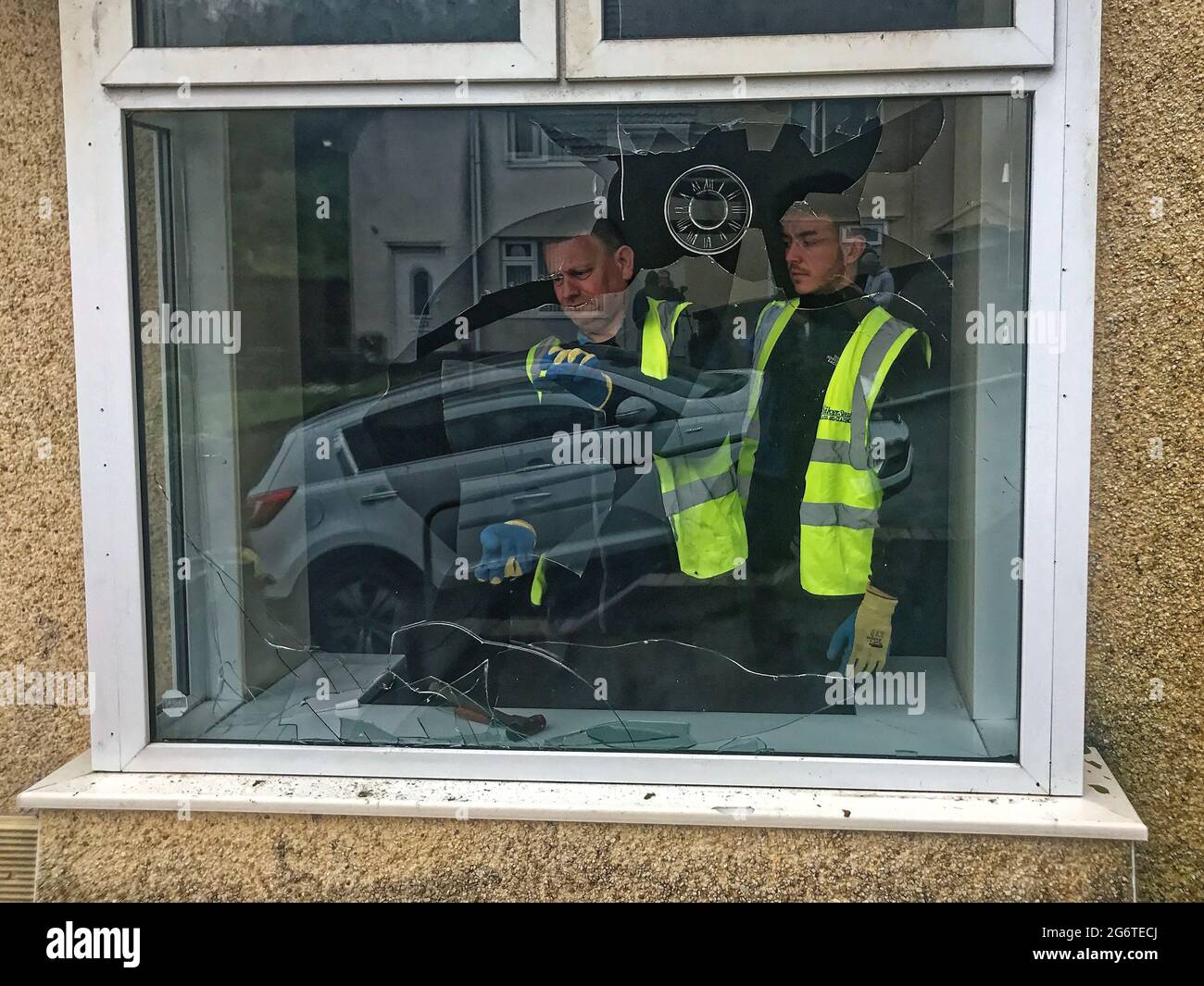 Pictured: A front room bay window is being repaired after being vandalised in Waun-Wen Road in the Mayhill area of Swansea, Wales, UK. Friday 21 May 2 Stock Photo