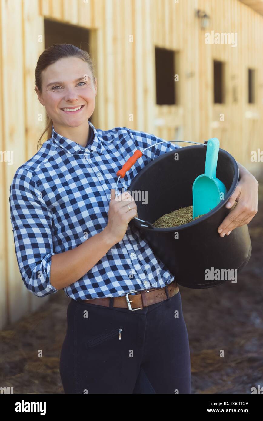 Horse owner holding a bucket full
