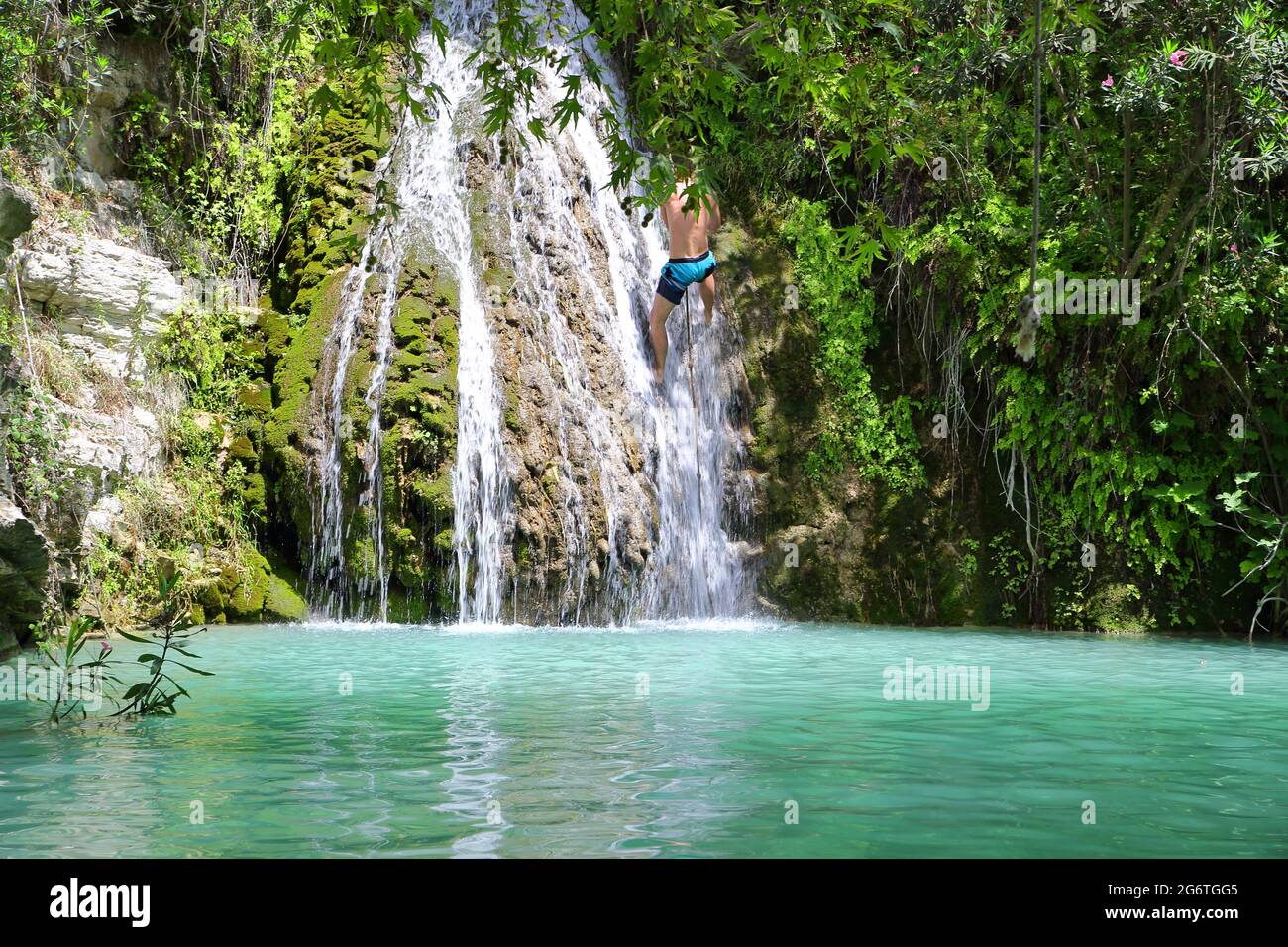 Azure color water in mountain pond, waterfall, rich tropical greenery