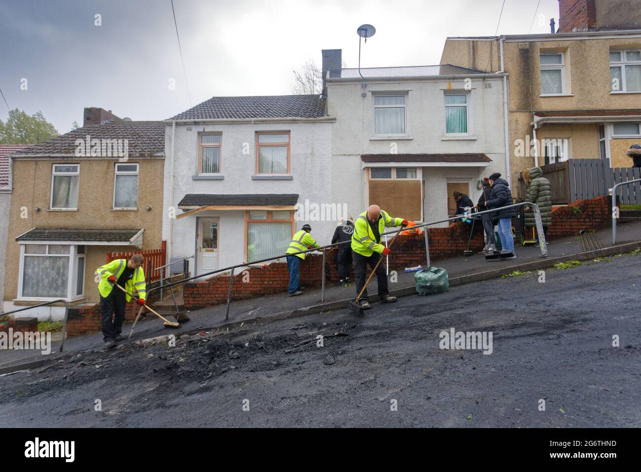 Pictured: Locals and Council workers clean up in Waun-Wen Road in the Mayhill area of Swansea, Wales, UK. Friday 21 May 2021 Re: Gangs of 'yobs' have Stock Photo