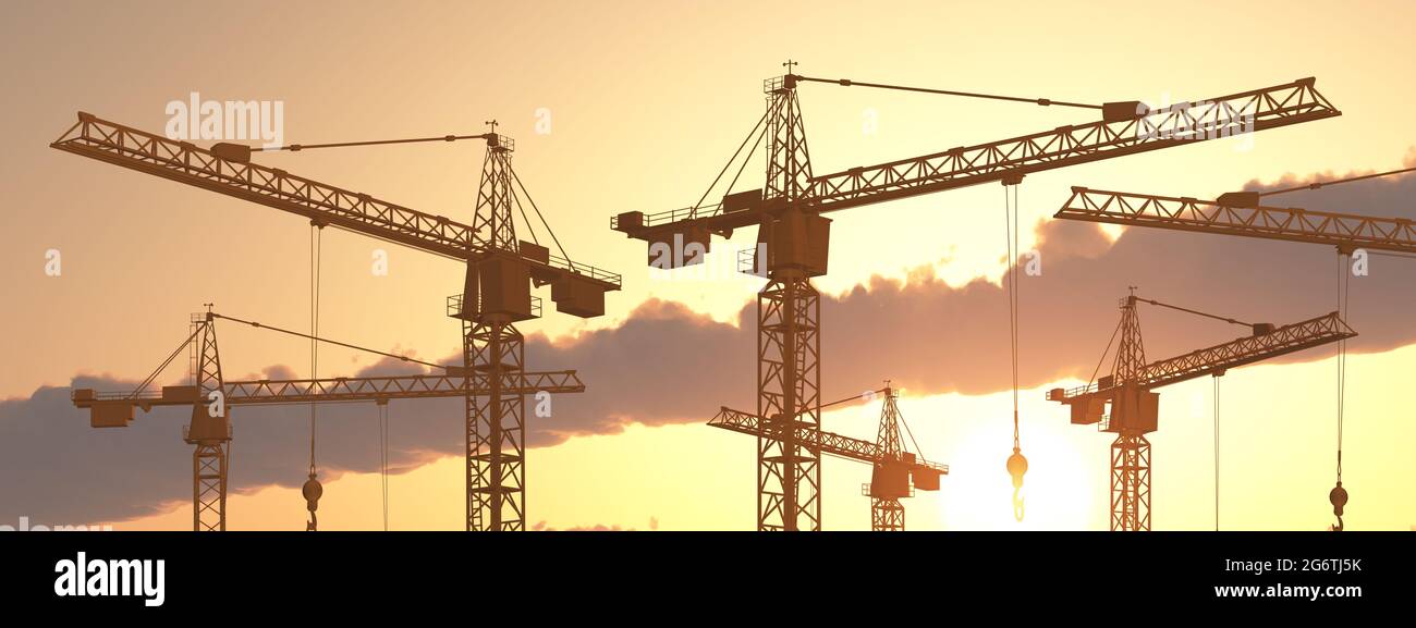 Construction cranes at sunset Stock Photo