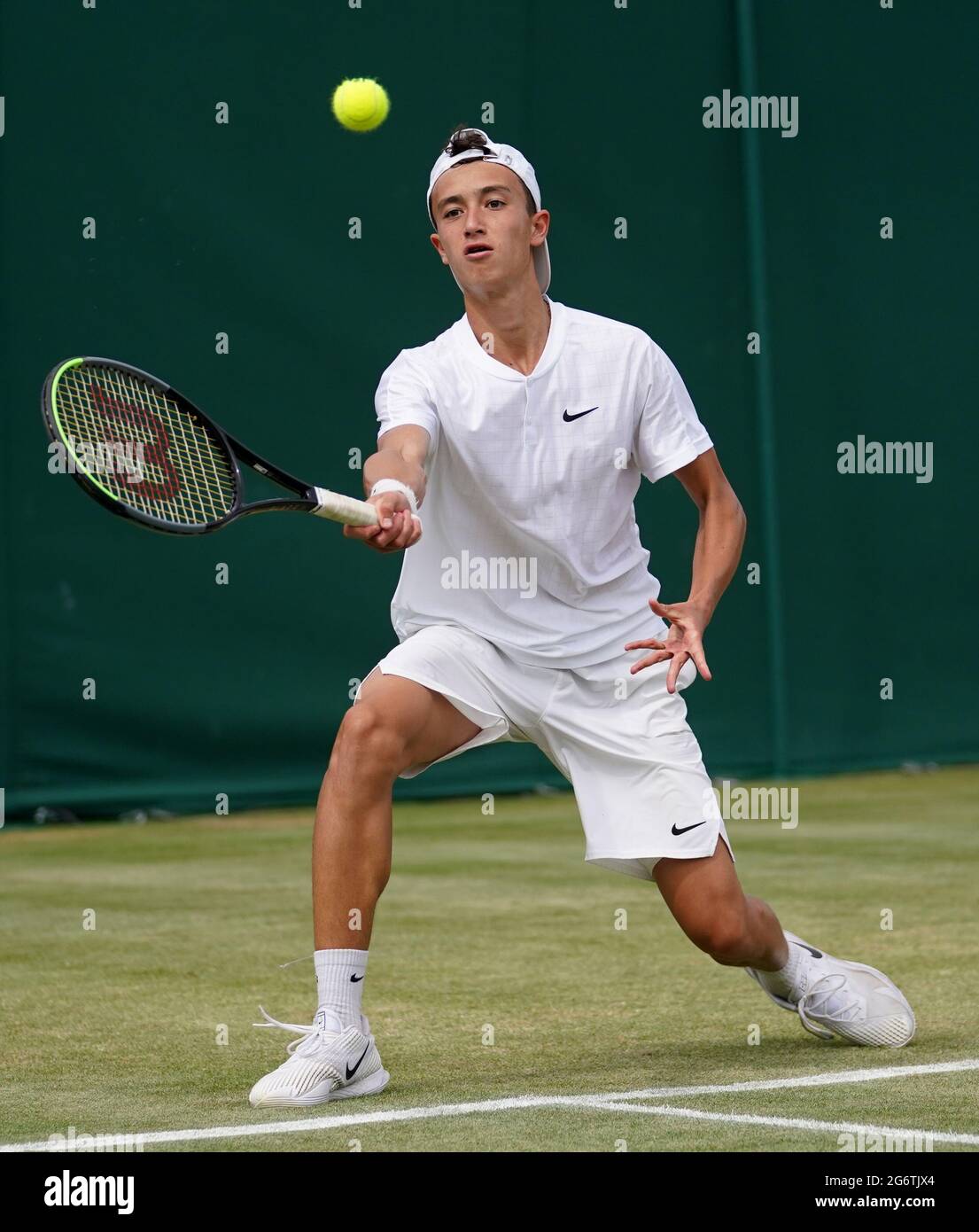 Patrick Brady in action against Max Hans Rehberg during their boys' singles  second round match on day ten of Wimbledon at The All England Lawn Tennis  and Croquet Club, Wimbledon. Picture date: