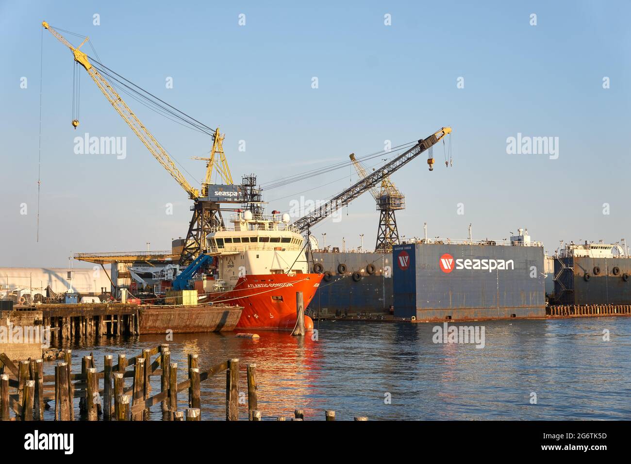 The Atlantic Condor offshore supply ship and tug docked at the Vancouver Drydock facility in  North Vancouver, British Columbia, Canada Stock Photo