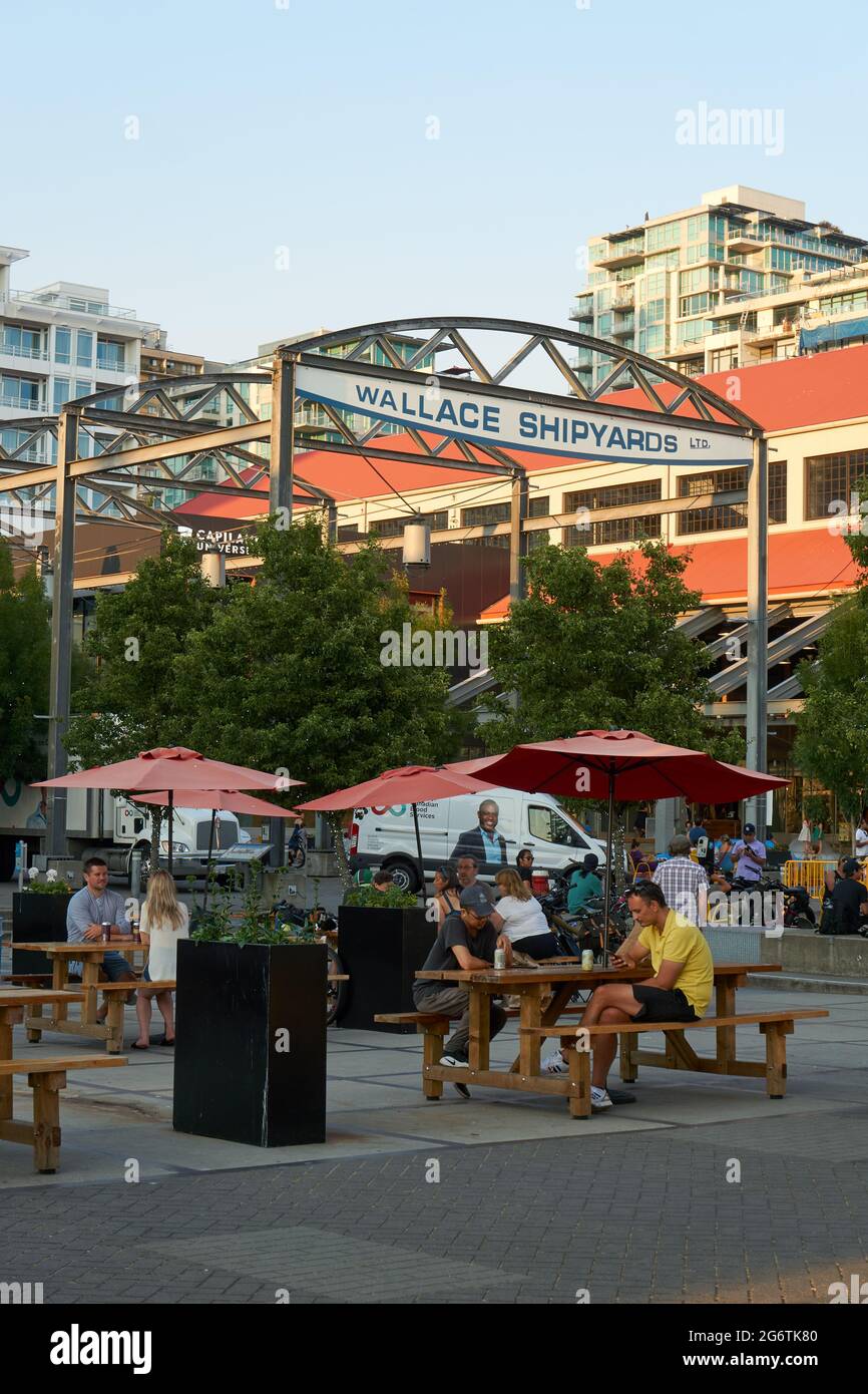 People relaxing outdoors at the Shipyards Commons community development in  North Vancouver, British Columbia, Canada Stock Photo