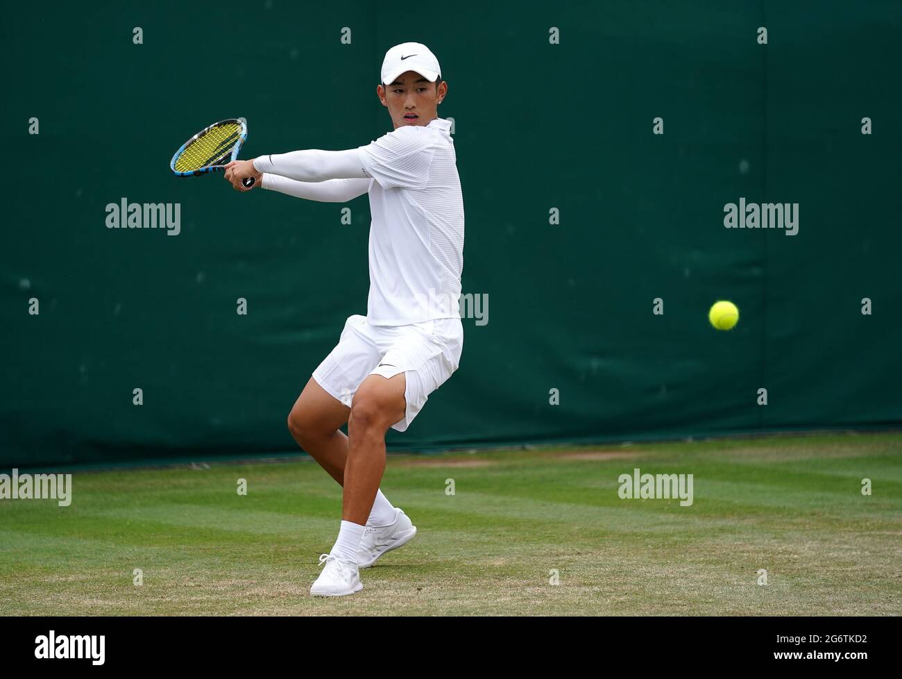 Juncheng Shang in action against Robin Bertrand during their boys' singles  second round match on day ten of Wimbledon at The All England Lawn Tennis  and Croquet Club, Wimbledon. Picture date: Thursday