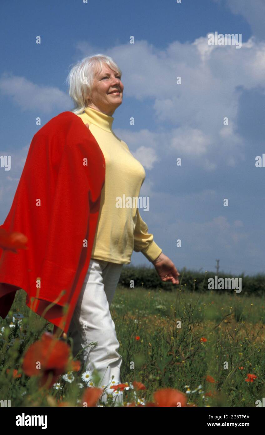mature woman walking in countryside Stock Photo