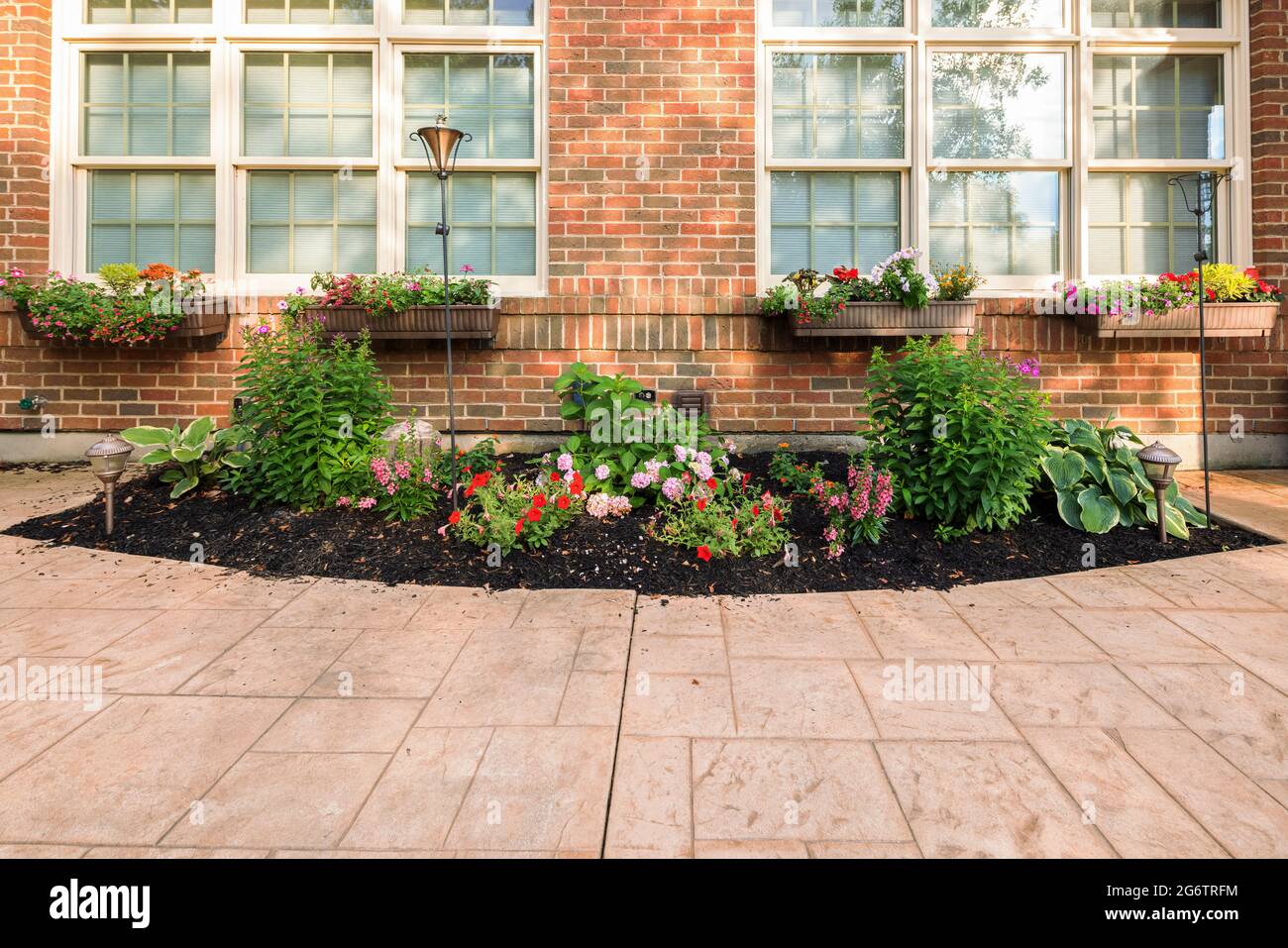 Backyard Flower Bed and Window Flower Boxes in Summer Stock Photo