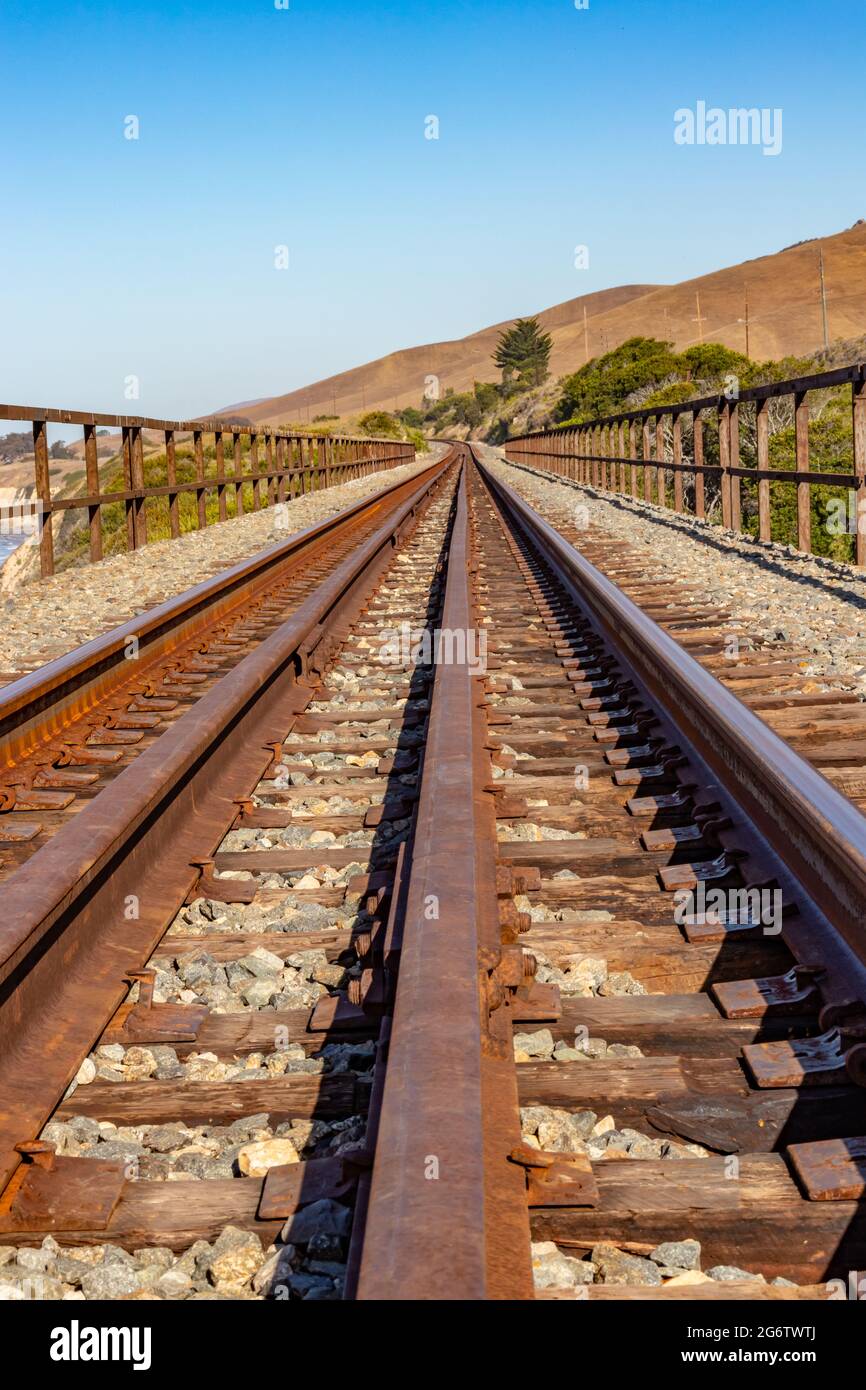 Closeup of railroad tracks converging at the horizon Stock Photo