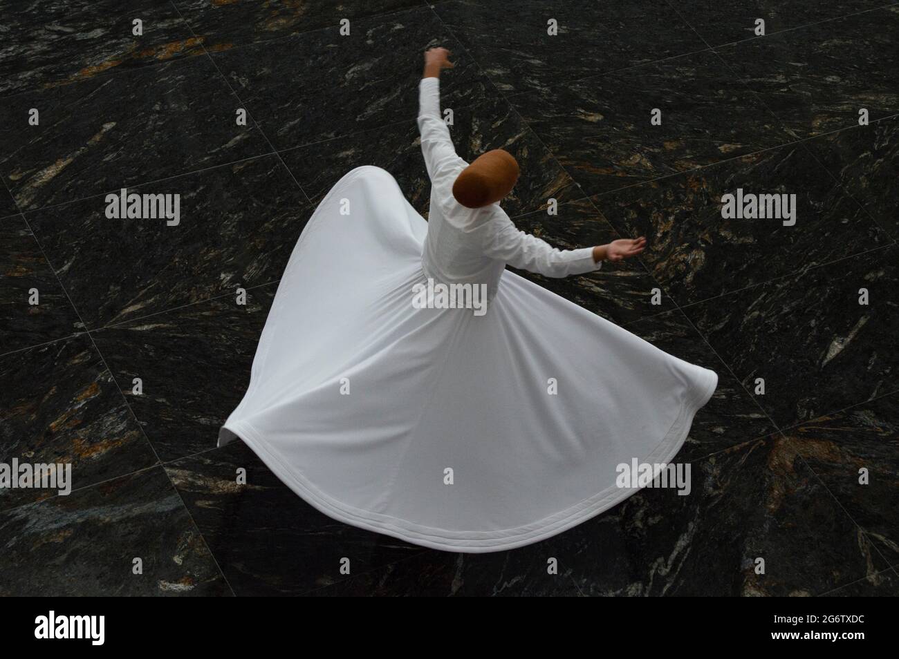 The image of whirling dervish on isolated or patterned background, Dervish is whirling for pray Stock Photo