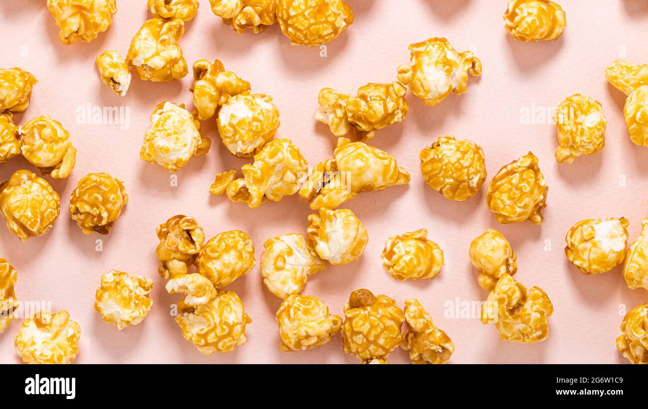 caramel popcorn on a pastel pink background. Stock Photo