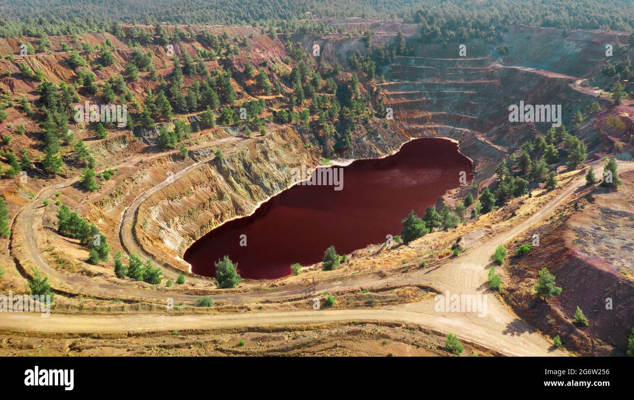 Acidic red lake in open pit of abandoned Kokkinopezoula copper mine in