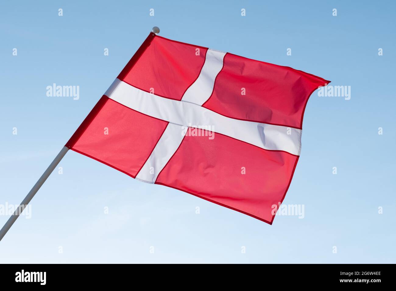 Flag of Denmark on blue sky background. Stock Photo