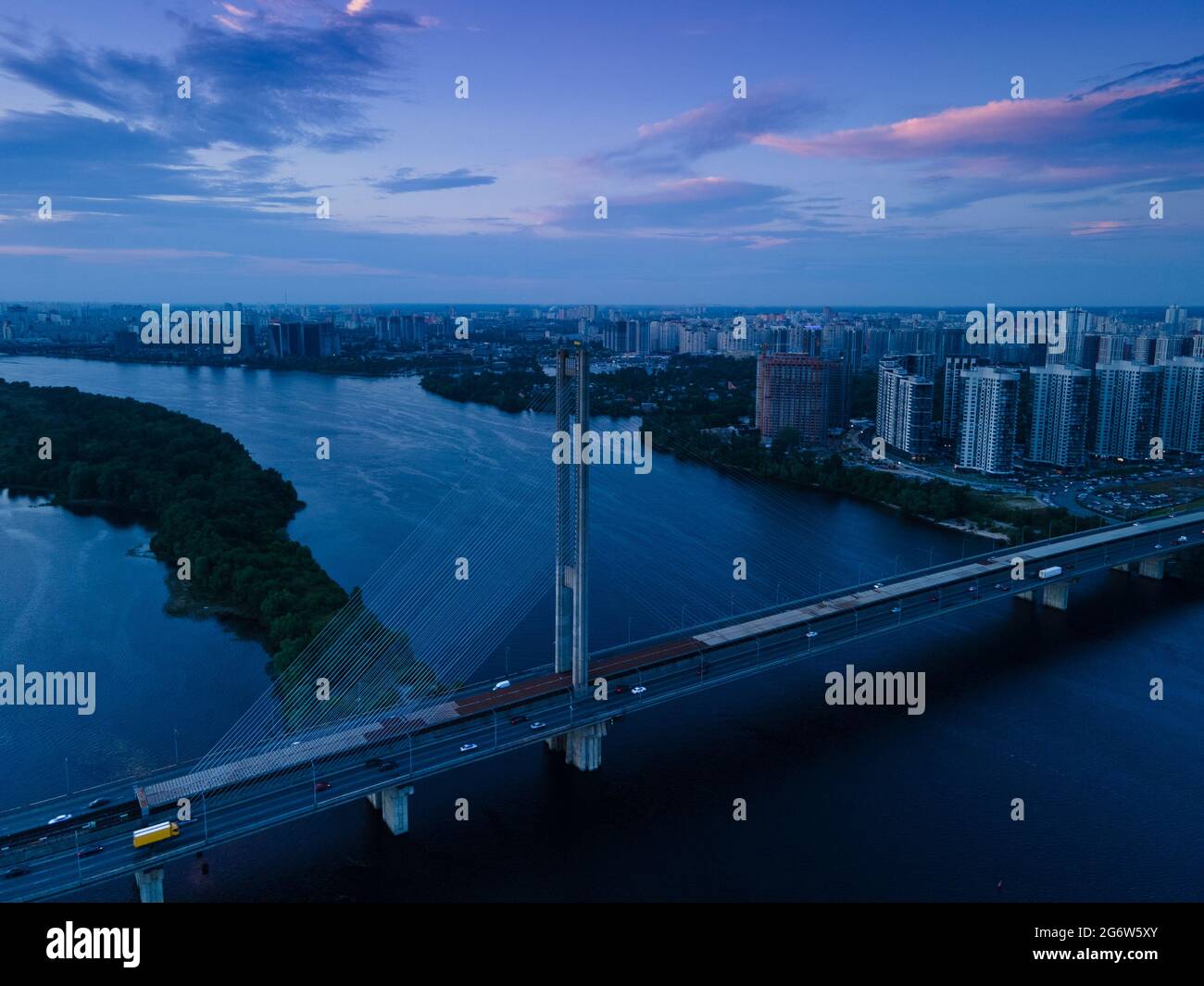 Aerial view from a drone on a cable-stayed bridge on a river in the evening Stock Photo