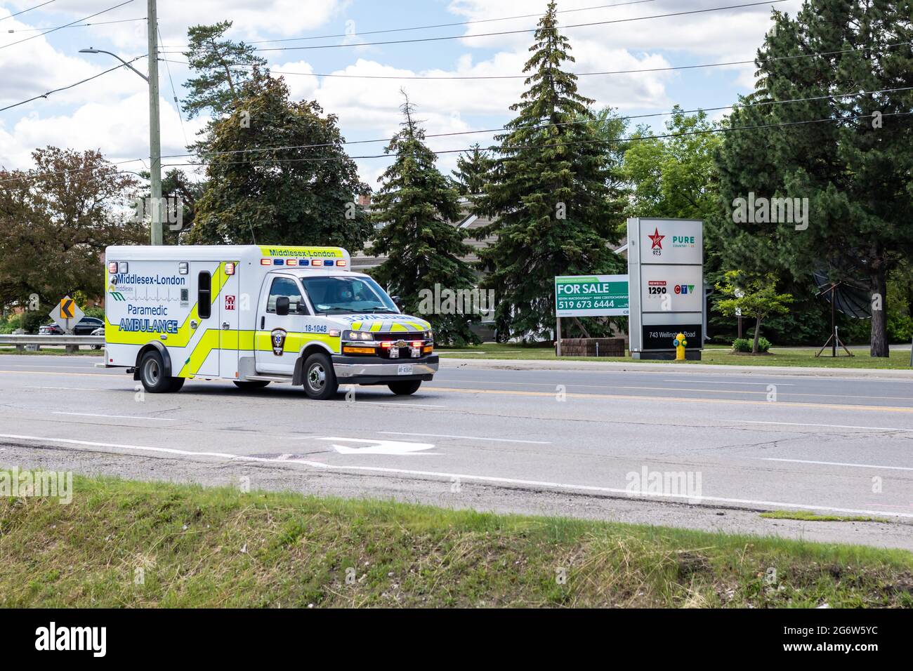 London, Ontario, Canada - June 22 2021: A Middlesex-London EMS paramedic ambulance drives down Wellington Road with its lights flashing. Stock Photo