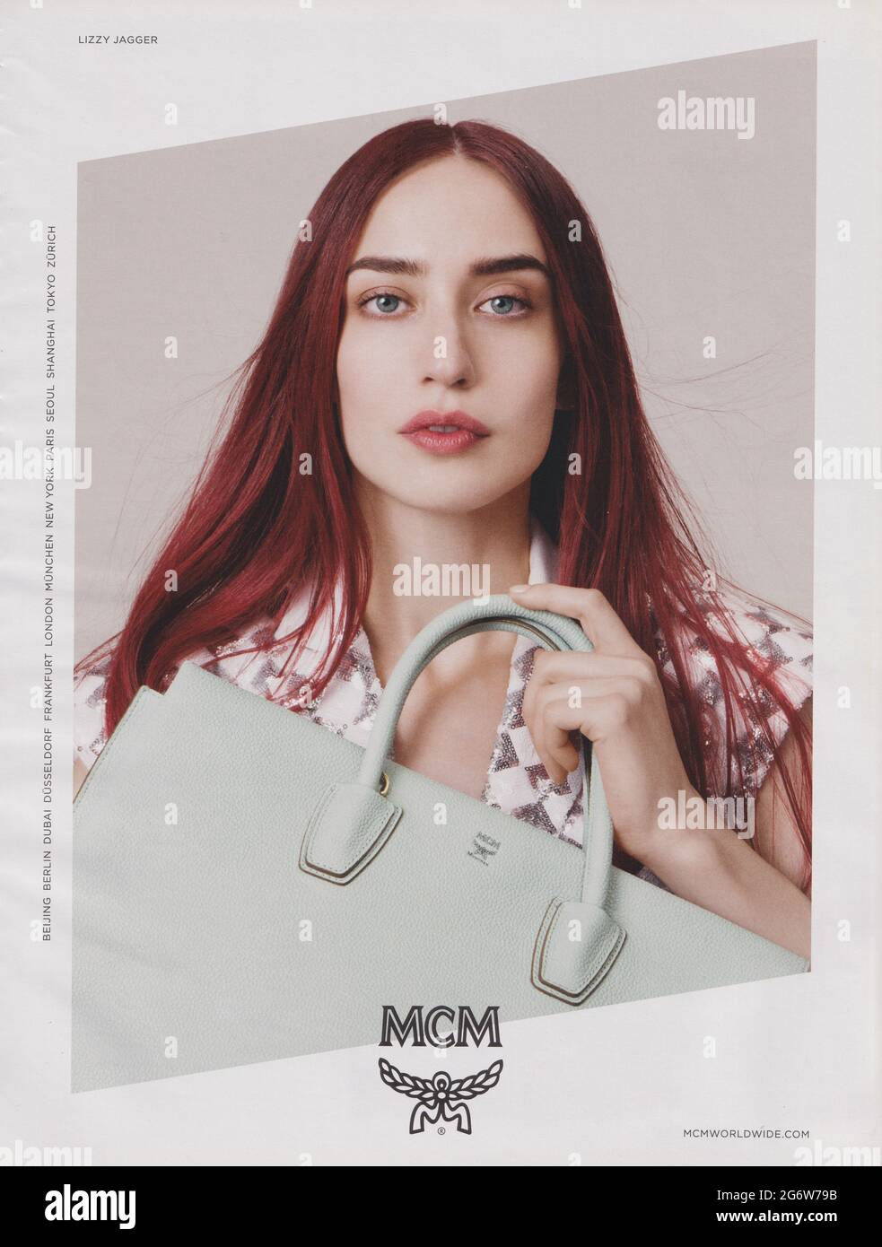 poster advertising MCM fashion house with Lizzy Jagger in magazine from 2015, advertisement, creative MCM 2010s advert Stock Photo