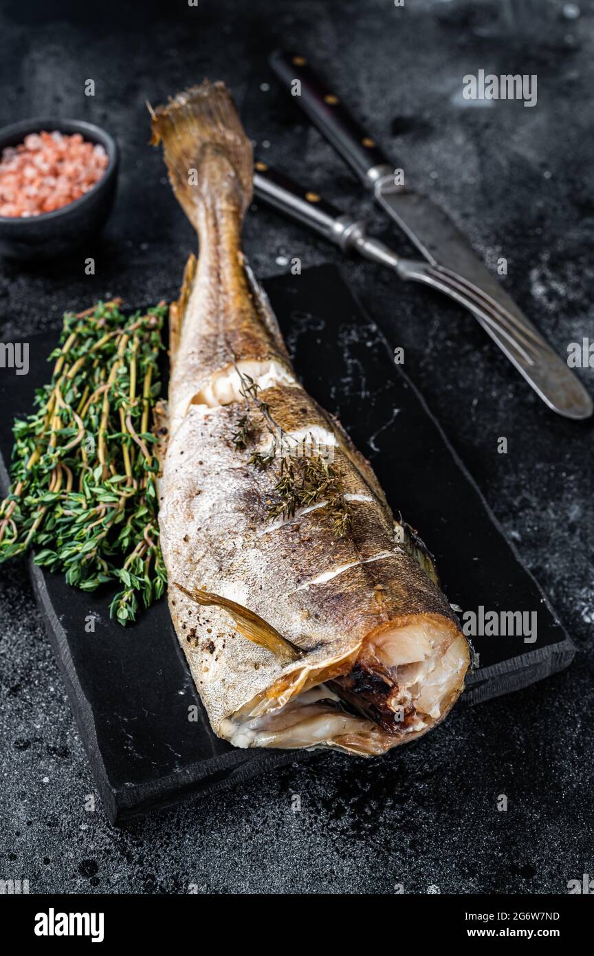Roasted cod white fish with thyme on marble board. Black background ...