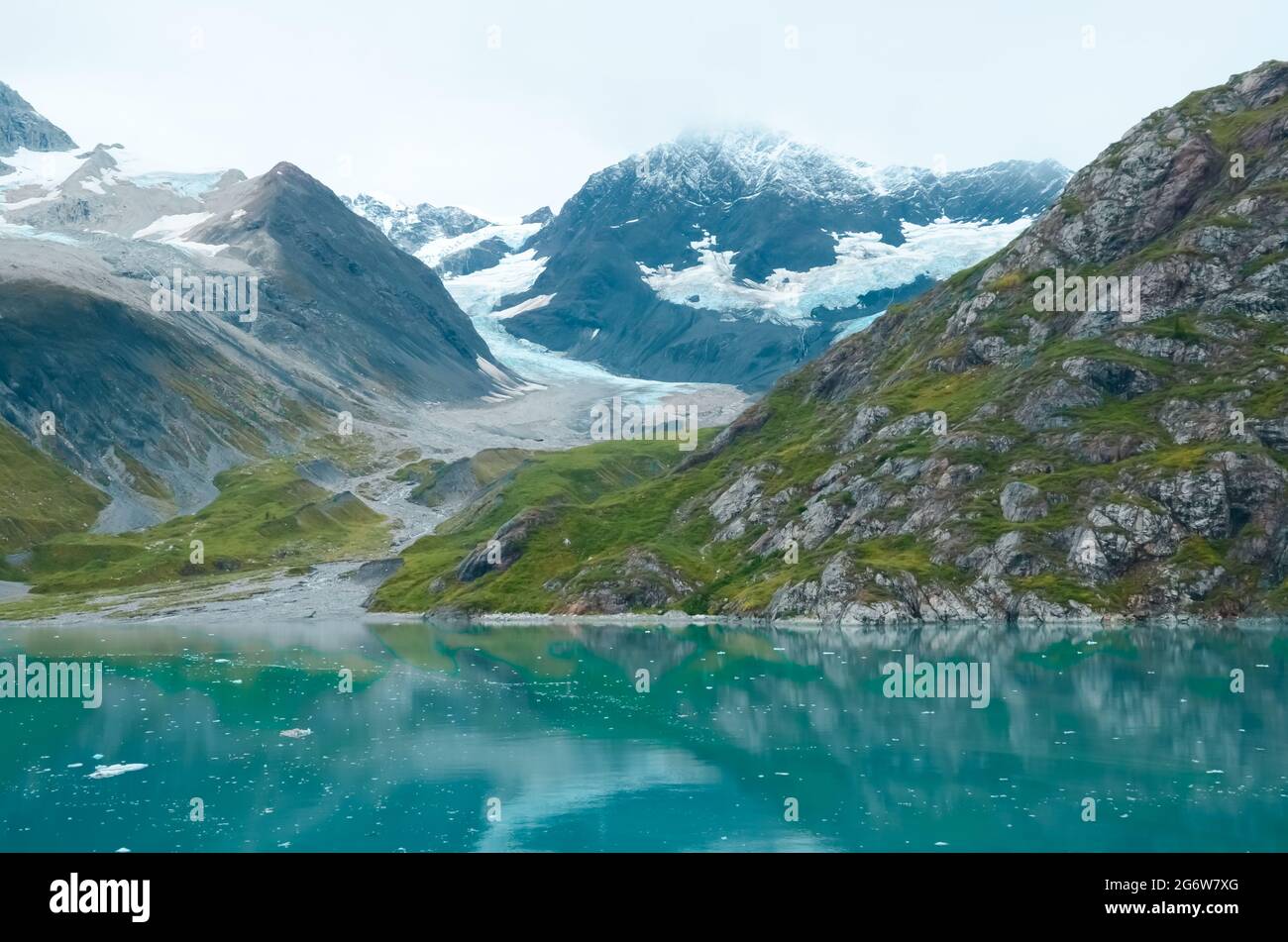 Alaska cloudy landscape mountains and water. Mountains reflection in the water. Remote location, unplugged. Wild beauty in nature. Untouched environment Stock -