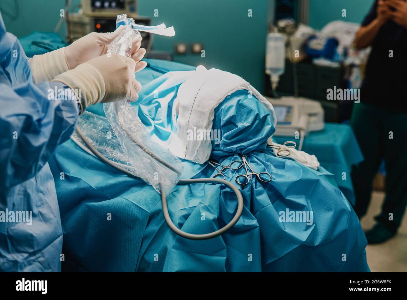 Surgeon team operating patient in surgical room at hospital - Focus on scissors Stock Photo